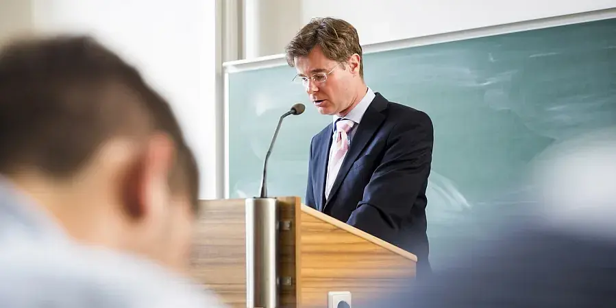 Ein Dozent im Hörsaal am Pult