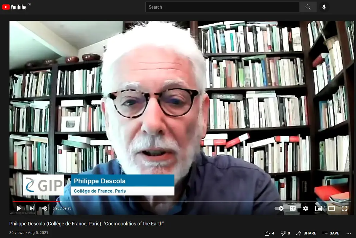 An older man sitting in front of a webcam and presenting